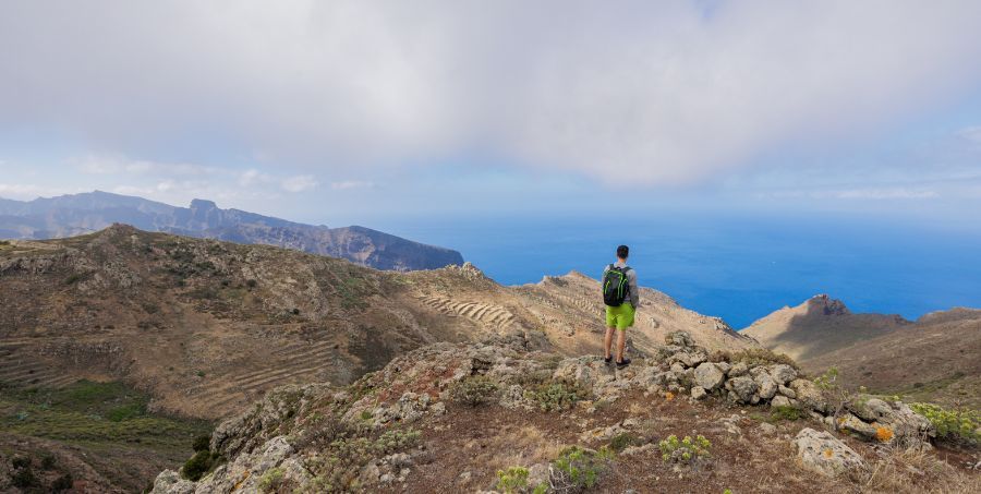 hiker-overlooking-mountains-coastline-tenerife-canary-islands.jpg