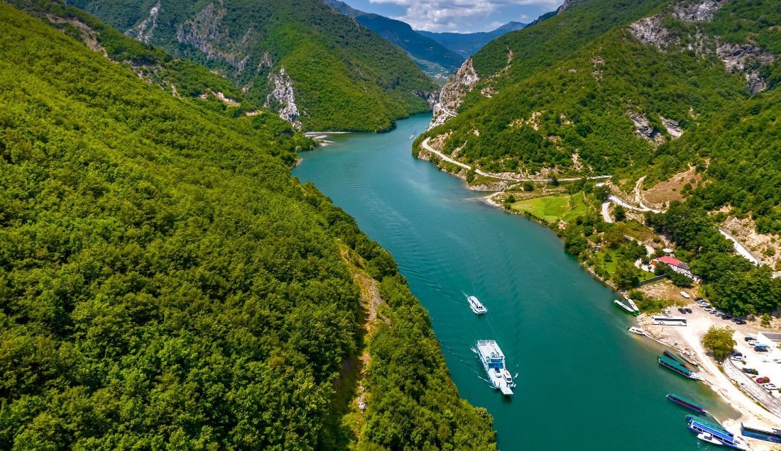 Enjoy a scenic ferry trip on Lake Komani.